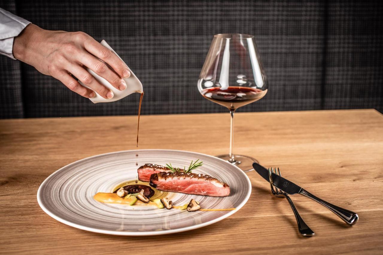 My Arbor - Dolomites Hotel Bressanone Exterior foto A server pouring sauce onto a prepared dish